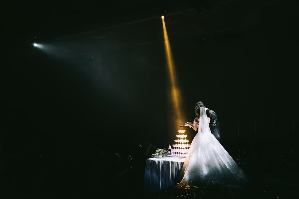 Bride and groom beside their head table lit in a soft warm glow at a Montana lodge