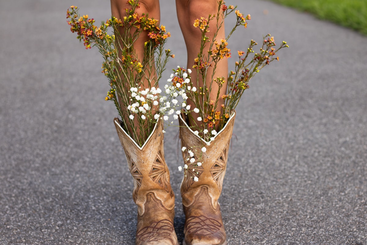 Bride wearing cowboy boots under wedding dress at Montana wedding