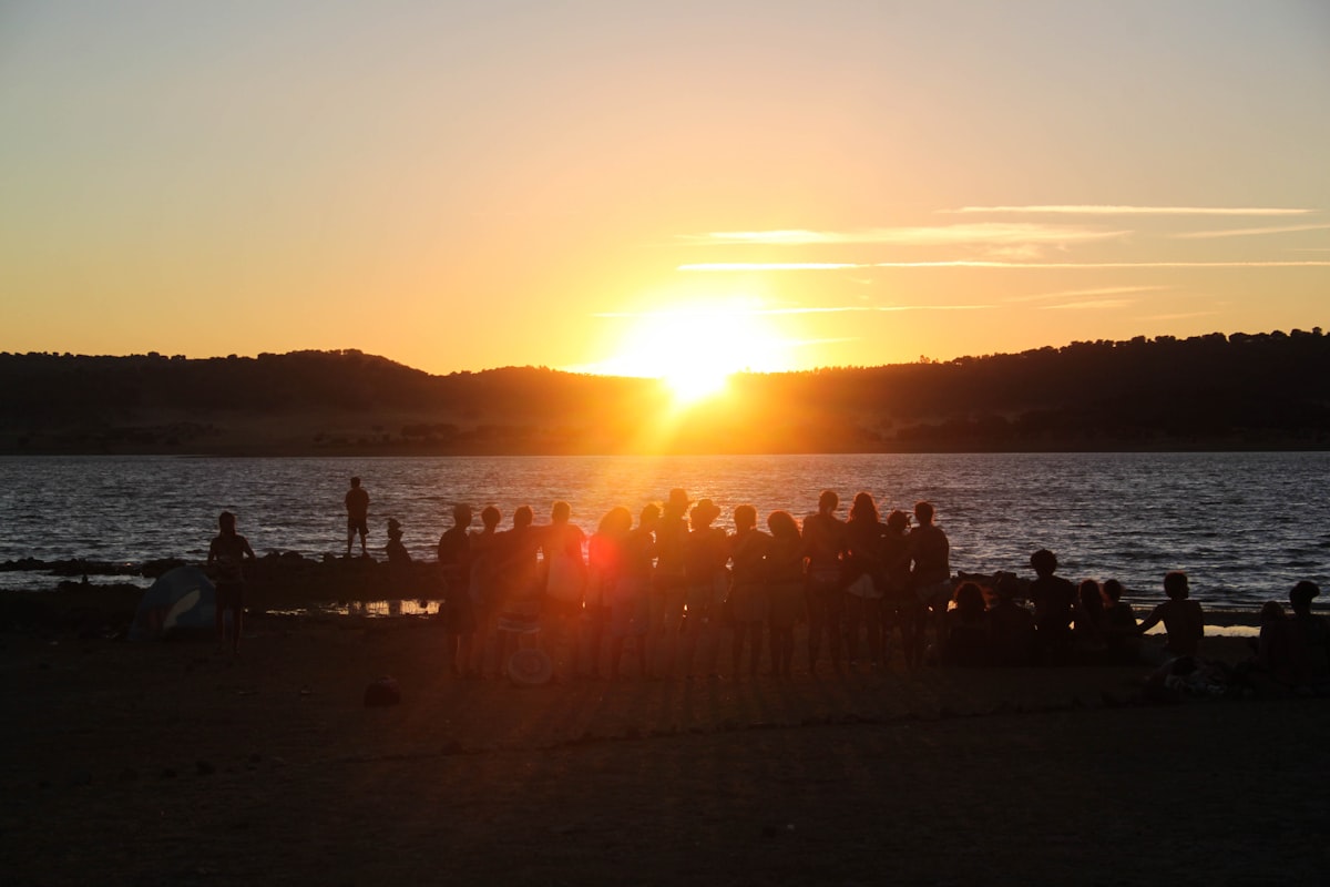 Wedding guests dancing at lakeside reception during Montana sunset