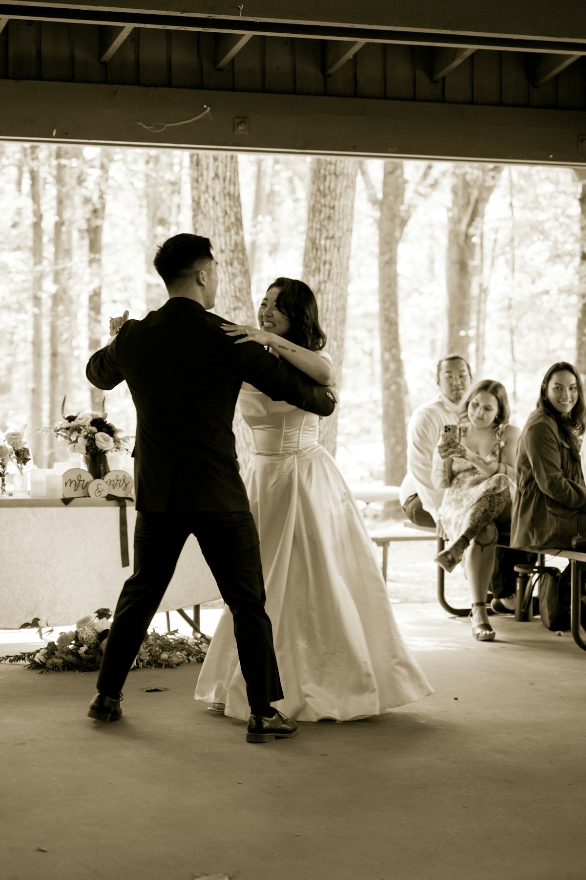 Couple dancing at an outdoor Flathead Lake area wedding reception with DJ sound system in the background