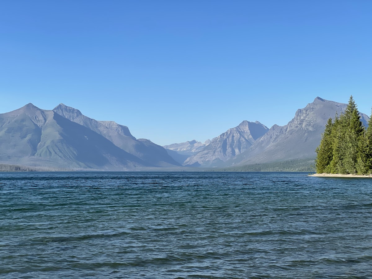 Wedding ceremony at Glacier National Park with mountain backdrop and acoustic setup