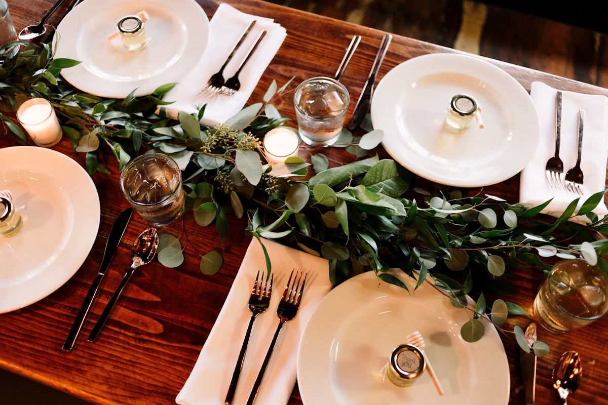 Warm amber uplighting illuminating a rustic barn reception space at a Glacier country wedding