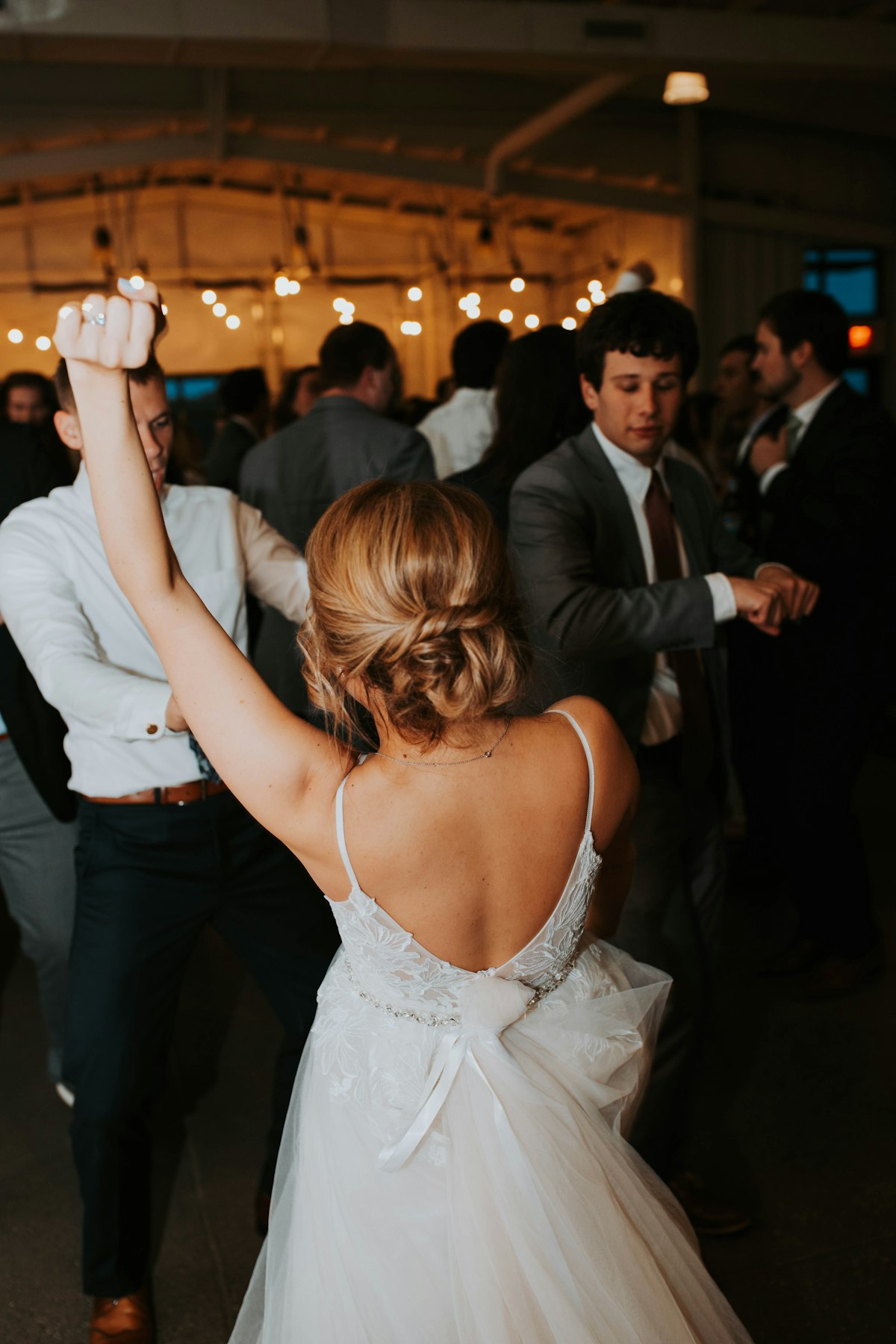 Reception under string lights at a Montana mountain lodge for an out-of-state weekend wedding