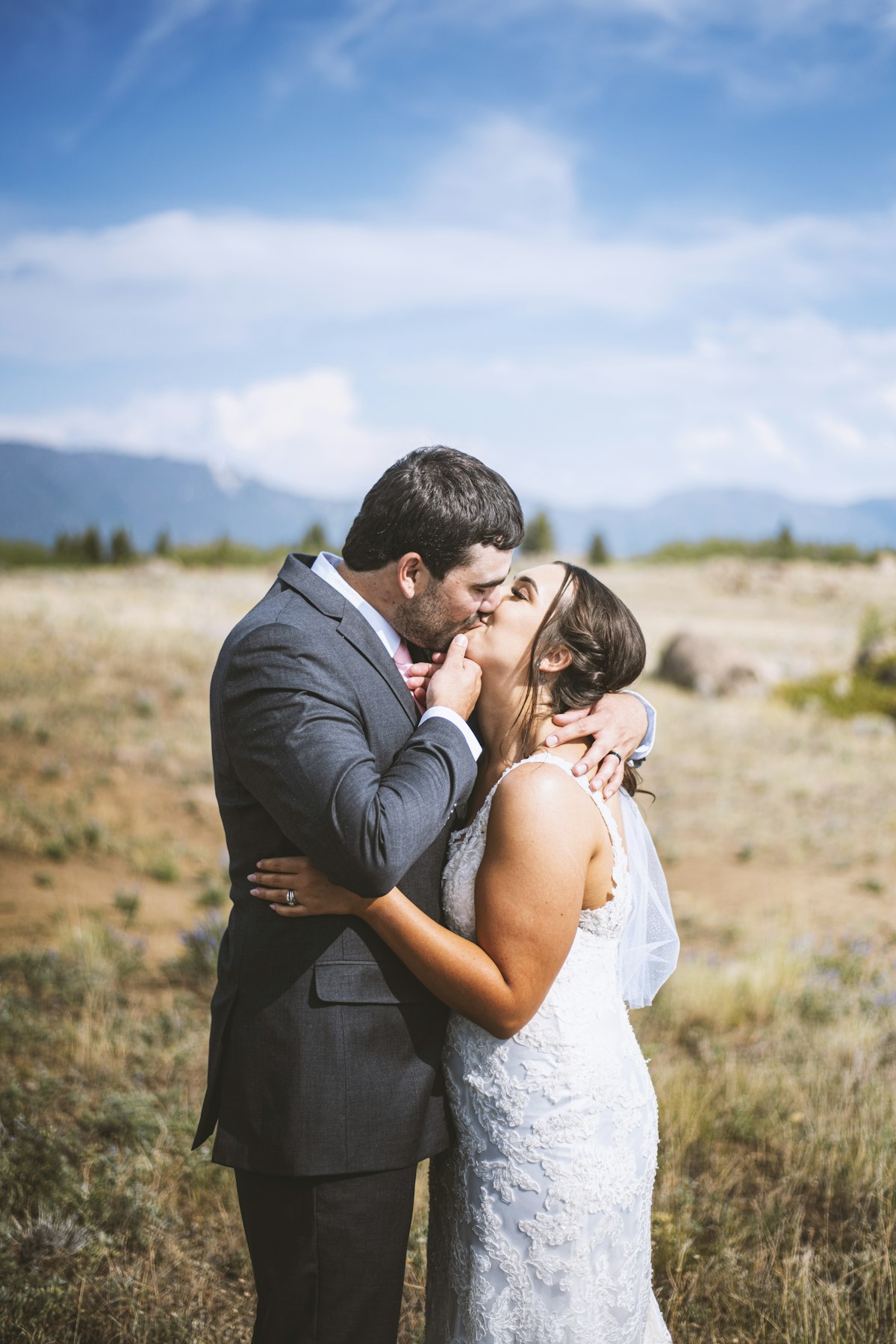 Guests seated at a sunset outdoor ceremony in a Montana mountain valley for a destination wedding