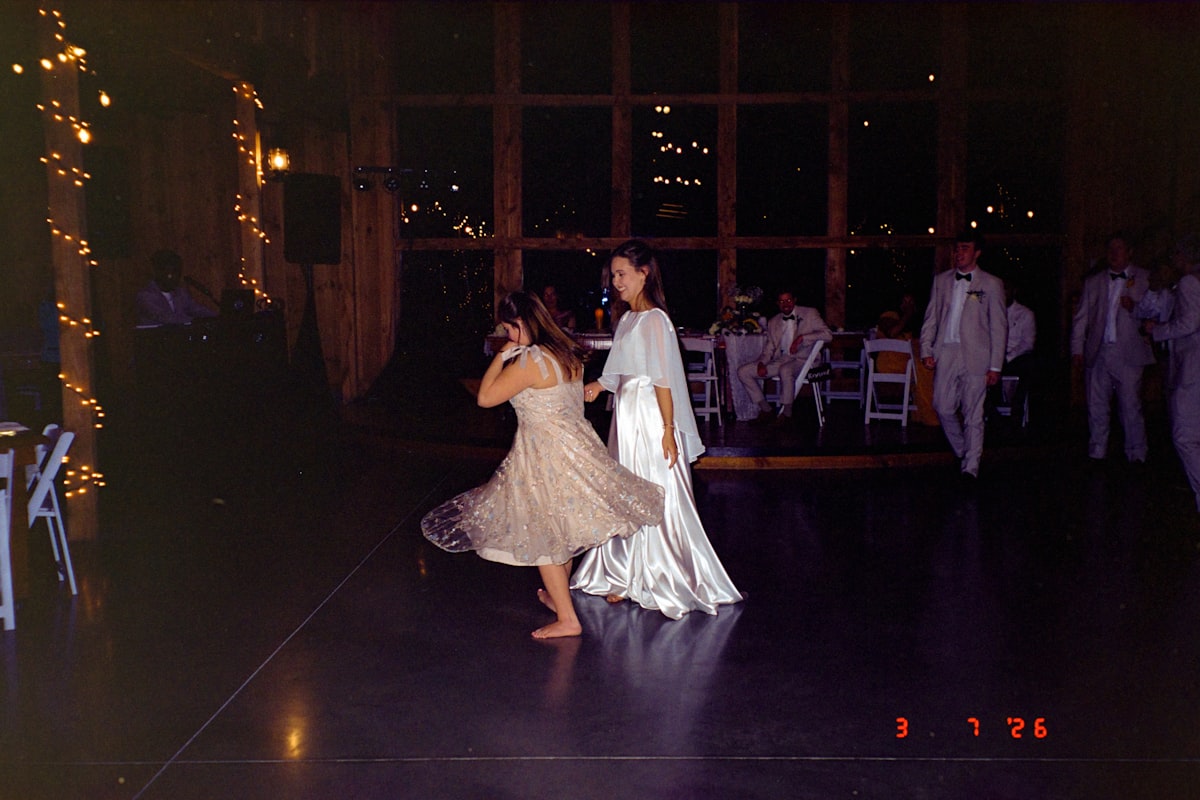 Wedding guests dancing at Montana reception with DJ in background