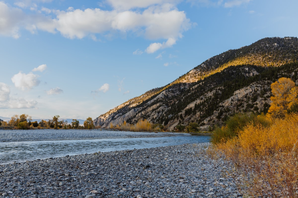 Wedding setup at riverside ranch venue with mountain backdrop in Montana