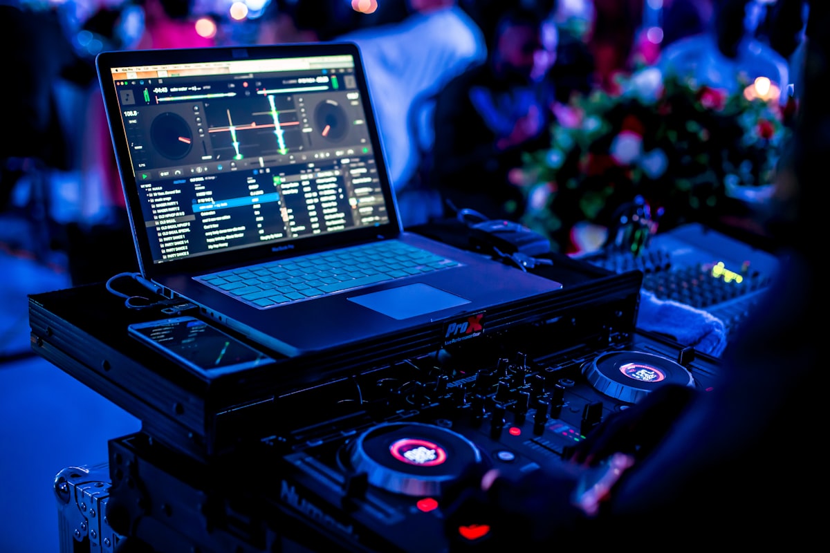DJ loading sound gear into a Montana ranch estate venue with mountains in the background