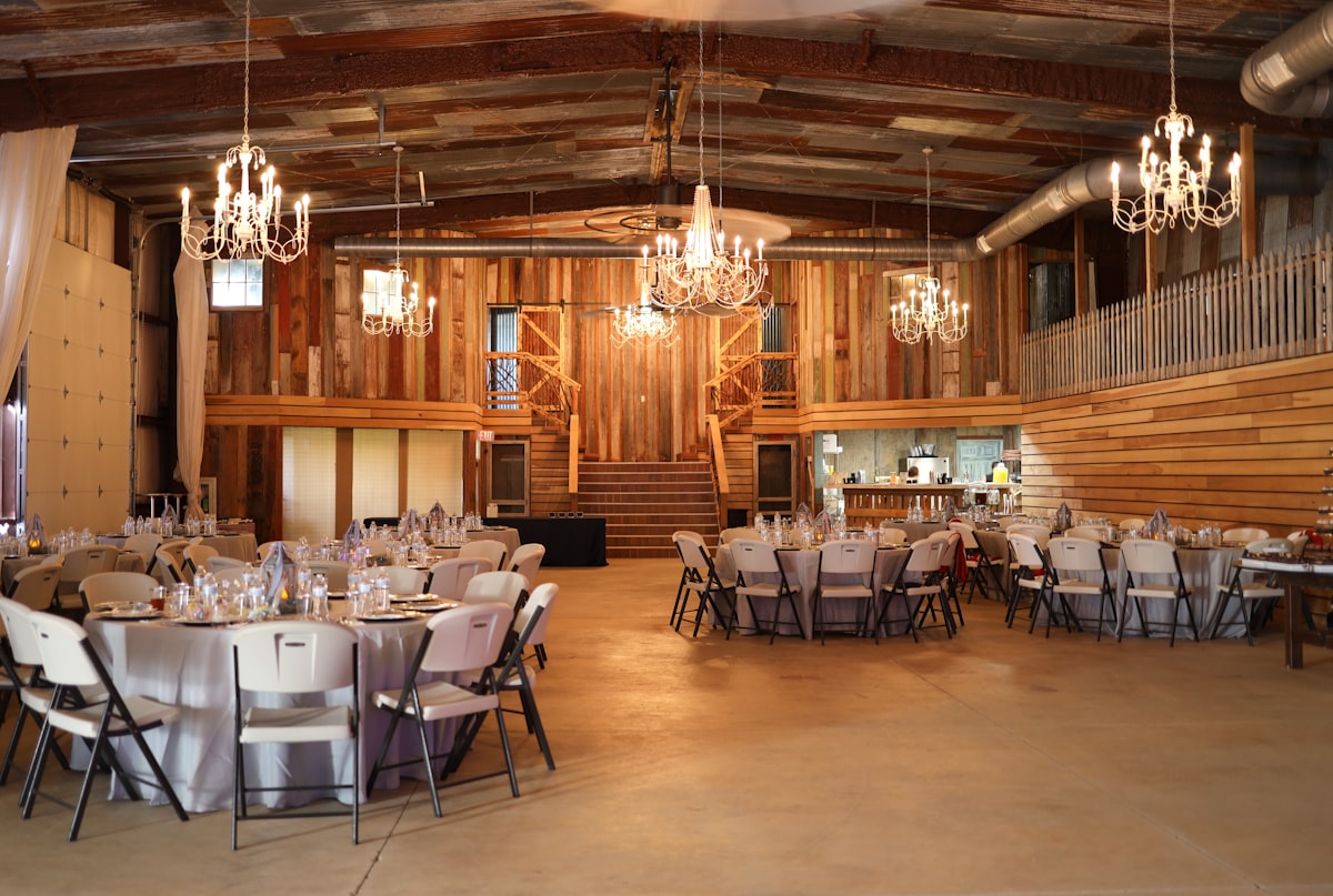 a banquet hall with chandeliers and tables