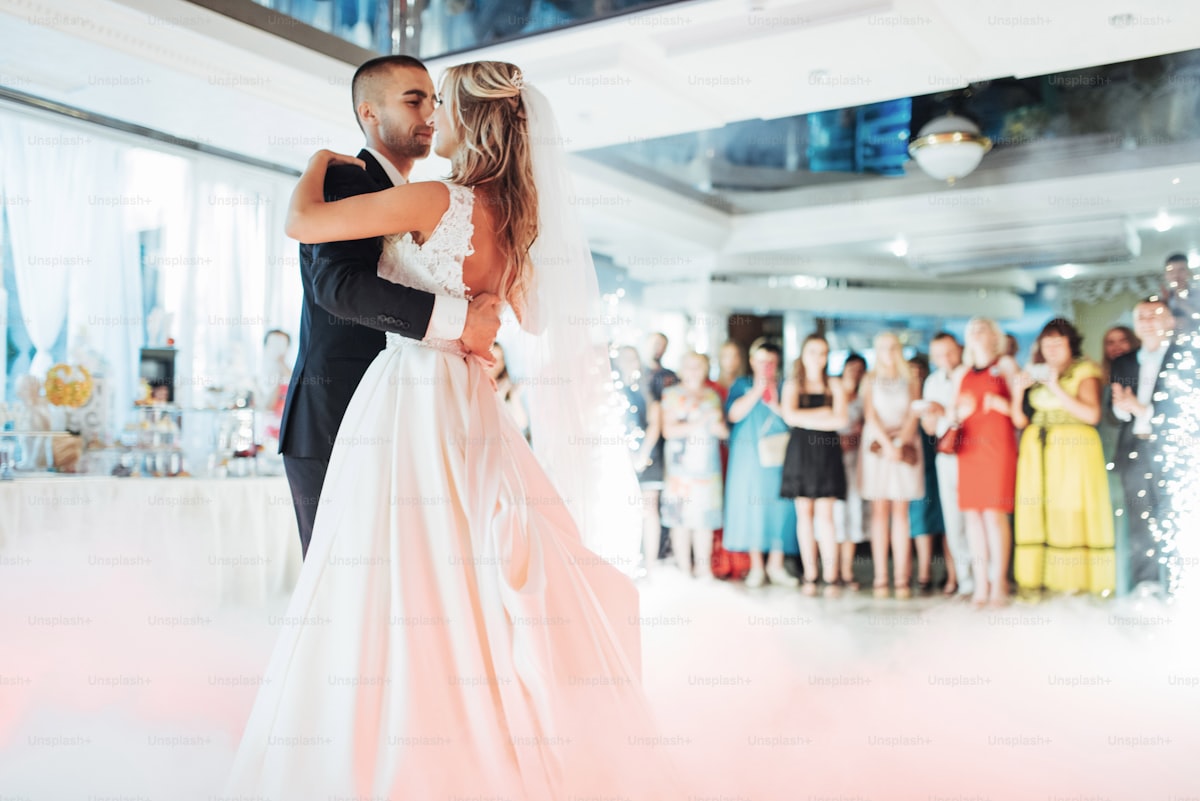 Happy bride and groom and their first dance, wedding in the elegant restaurant with a wonderful ligh