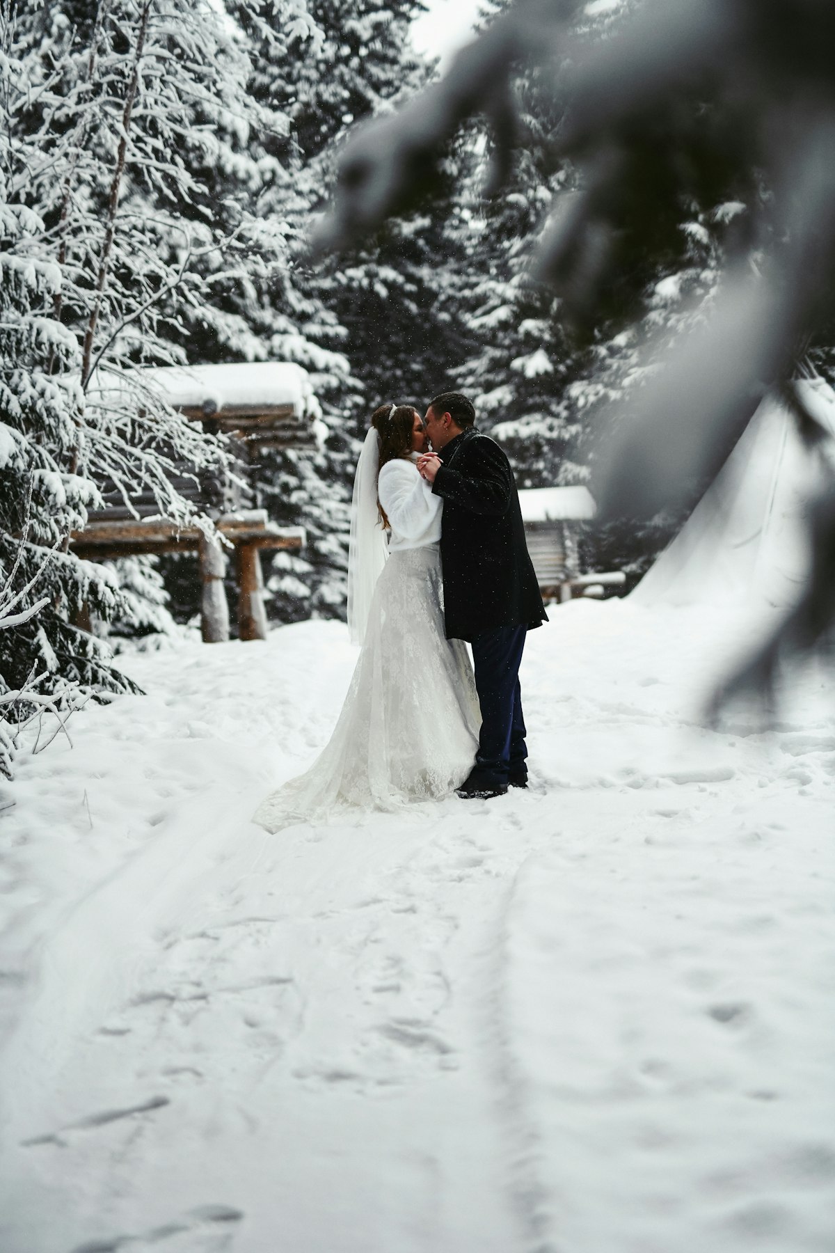 Cozy winter wedding inside a Montana mountain lodge lit with warm string lights